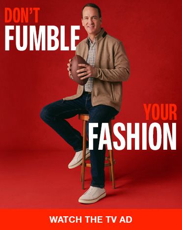 Red banner featuring Peyton Manning sitting on stool, dressed casually in Johnston & Murphy clothes with football in hand. Don't Fumble Your Fashion reads across the image with a CTA to watch the Tv Ad