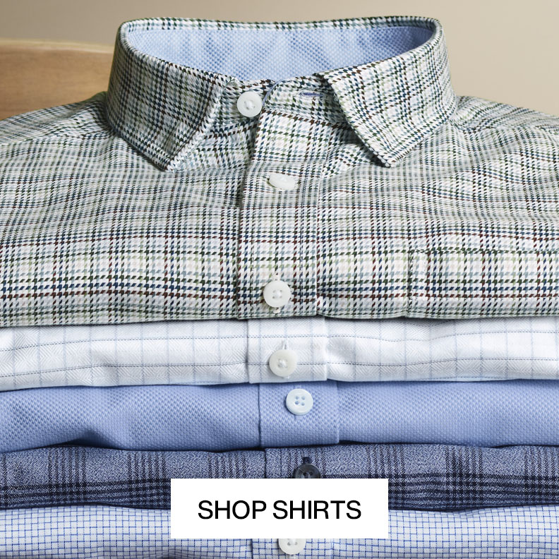 Stack of men's button-down shirts in assorted plaid, check and solid patterns with text that reads shop shirts.