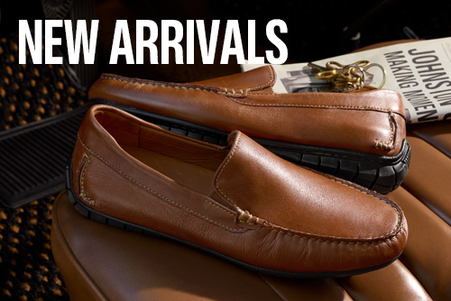 Small banner with a pair of mens Johnston & Murphy brown loafers sitting on the seat of a car with keys and a newpaper in the background.