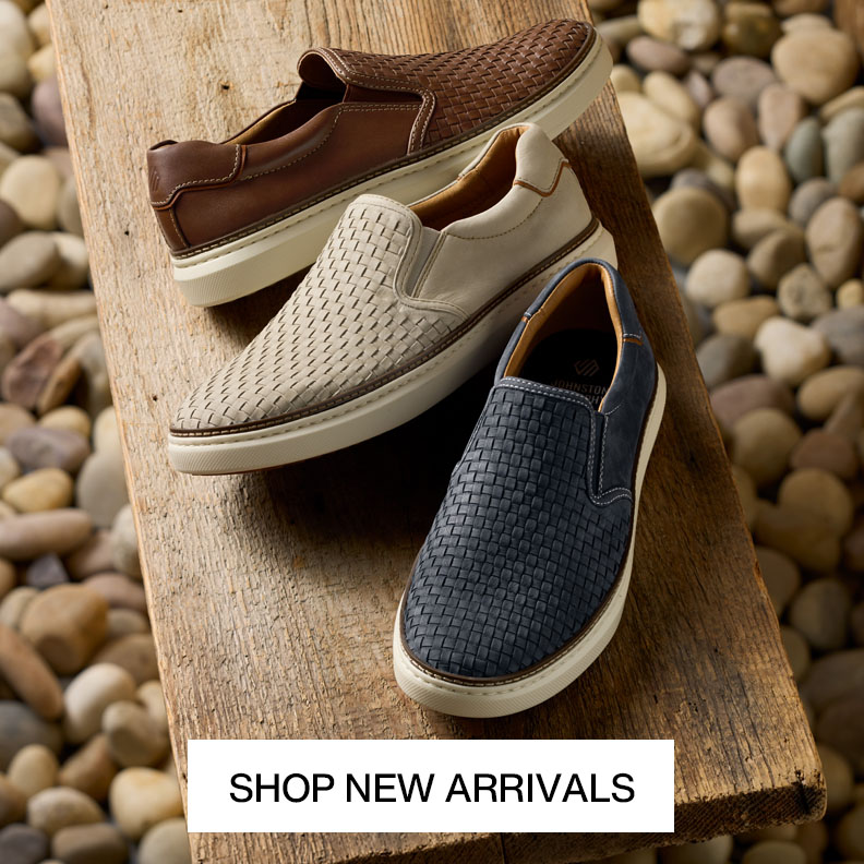 3 pairs of men's slip-on woven loafers in the colors brown, cream, and navy are shown on a bench with rocks in the background. Shop New Arrivals is overlayed on a button at the bottom of the picture.