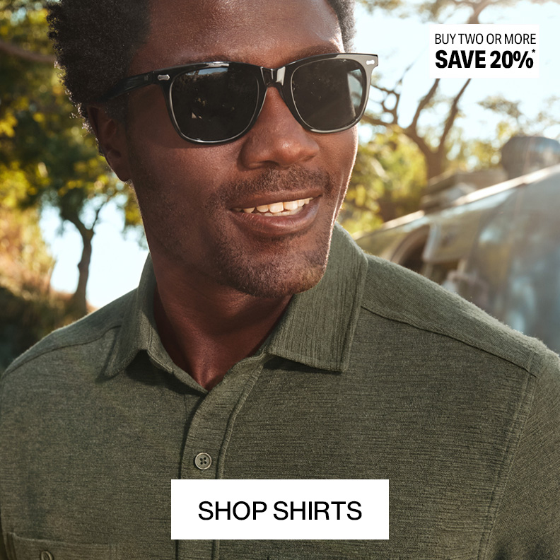 A closeup shot of a man's upper body show casing a blue paisley button-down shirt. He is looking to the left and wearing sunglasses. A banner that reads buy 2 or more, save 20% and shop shirts is shown on the picture.