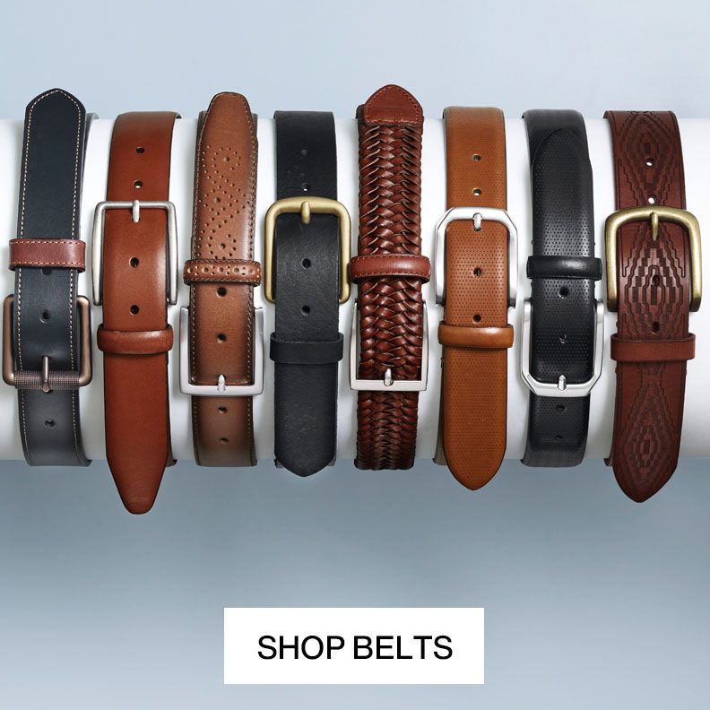 Flatlay of eight men's belts lined up in a row.