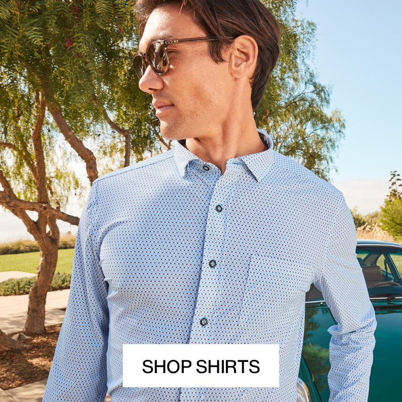 A closeup shot of a man's upper body show casing a blue button-down shirt. He is looking to the left and wearing sunglasses.