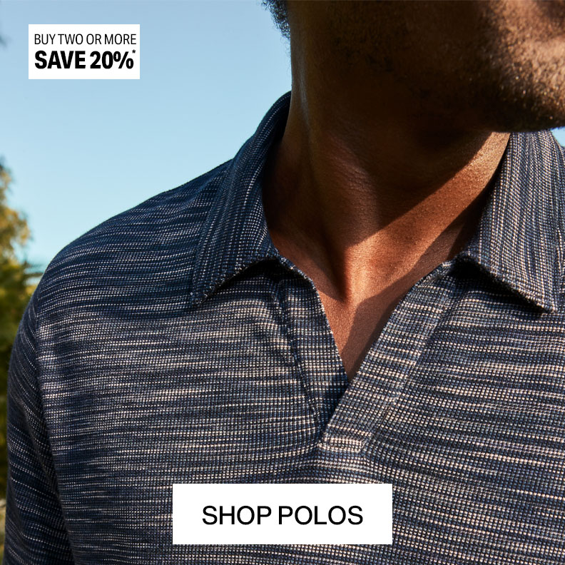 A closeup shot of a man's upper body show casing a blue button-down shirt. He is looking to the left and wearing sunglasses.